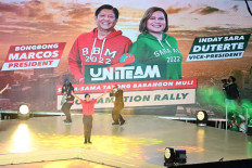 Ferdinand 'Bongbong' Marcos Jr (center, in red), Philippine presidential candidate and son of late dictator Ferdinand Marcos, gestures onstage to supporters during a campaign rally in Bocaue town, Bulacan province on February 8, 2022. 