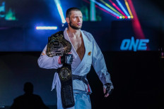 Two-division ONE world champion Reinier de Ridder walks into the Circle with a belt on his shoulder. 