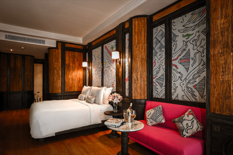 Luxury sleep: The Orient Hotel Jakarta's namesake room is adorned with oversized batik wall prints, while a king-sized bed is sheathed in Italian linen for quality sleep. (Courtesy of The Orient Hotel Jakarta)