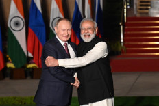 India's Prime Minister Narendra Modi (right) greets Russian President Vladimir Putin before a meeting at Hyderabad House in New Delhi on December 6, 2021. 