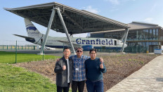 Nikolaus Evan Reinaldo (left), Dimas Aryo Budi (middle) and Rangga Ega Santoso (right) pose in front of a Boeing B737-400 airliner donated to the university by British Airways in 2014.