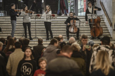 Musicians play for people living in a metro station used as a bomb shelter in Kharkiv on March 26, 2022, during Russia's military invasion launched on Ukraine.  