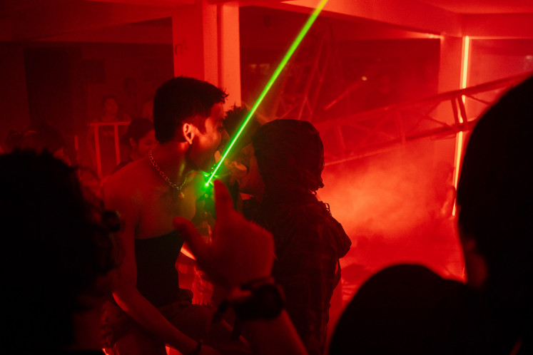 Rave: One-half of the electronic group Gabber Modus Operandi, Ican Harem (right), performs in front of a wilding crowd of people in the Ambruk Stage on March 26. (Courtesy of Joyland Bali-@fotokonser @nareend)
