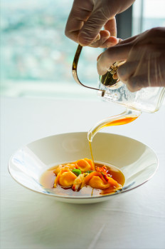 Flavorful main: Homemade agnolotti pasta filled with creamy burrata cheese is served in a pool of delicious seafood consommé and lobster meat at Four Seasons Jakarta's The Puglia Trilogy, which celebrates the southern Italian region of Puglia. (Courtesy of Four Seasons Hotel Jakarta)