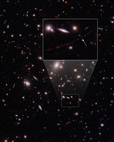 This image obtained from the European Space Agency on March 30, 2022, shows the star nicknamed Earendel (arrow) captured by the NASA/ESA Hubble Space Telescope, establishing a new record by detecting the light of a star that existed within the first billion years after the Universe’s Big Bang, the most distant individual star ever seen. The Hubble space telescope has peered back to the dawn of cosmic time and detected light from a star that existed within the first billion years after the Big Bang -- a new record, astronomers said on March 30, 2022. The newly discovered star, called 