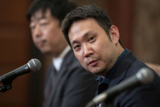 Japanese producer Teruhisa Yamamoto (back L) and director Ryusuke Hamaguchi (R) attend a press conference at the Japan National Press Club in Tokyo on April 5, 2022, after their film 'Drive My Car' won the Oscar for Best International Feature Film.