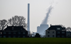 A coal-fired power plant can be seen behind houses in Werne, western German on March 24, 2022.