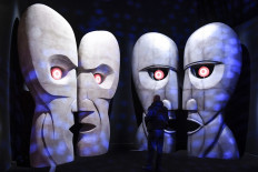Visitors walk in front of a replica of the 'The Division Bell Metal Heads'during the 'The Pink Floyd Exhibition: Their Mortal Remains' at the MACRO Museum in central Rome on January 16, 2018. 
