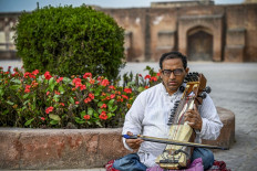 In this picture taken on February 25, 2022, Zohaib Hassan plays the sarangi at the historic Mughal-era Lahore Fort in Lahore, Pakistan.