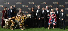 From page to stage: British actor and writer Lolita Chakrabarti (fourth left) poses with the crew and the puppet tiger of Life of Pi on Sunday to attend the Olivier Awards at Royal Albert Hall in central London.