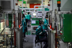 Employees work on a production line at a Schneider Electrical factory during a media tour in Beijing, China, on Feb. 17, 2022.



