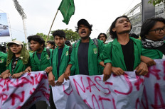 Students march during a protest against high prices of supplies, postponement of presidential elections and an extension of the President's term in Jakarta on April 11, 2022. 