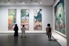 In this file photo taken on September 15, 2021, a woman looks at paintings by French painter Pierre Bonnard during a press visit of the exhibition 'The Morozov Collection' at the Fondation Louis Vuitton in Paris.