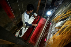 Preserving heritage: A worker uses a hand loom to weave a Banarasi silk sari at a workshop in Varanasi, Uttar Pradesh, India, on Nov. 20, 2021.