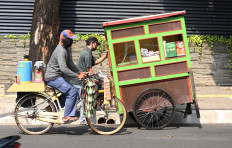 Street stall vendors arrive to sell their wares in Jakarta on September 10, 2020.
