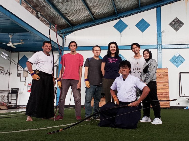 Strike a pose: Members of Heki Ryu Indonesia are pictured with their two-meter long 'yumi' after a practice session at their temporary dojo in Buaran, Jakarta. (Courtesy of Heki Ryu Indonesia)