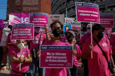 Gender solidarity: Male members of an activist group attend a demonstration to highlight the struggles and issues faced by Filipino women in Quezon City, suburban Manila, on March 6, ahead of International Women's Day. 