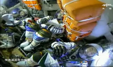 This screen grab made from video released by Chinese state broadcaster CCTV shows (left-right) Chinese astronauts Wang Yaping, Zhai Zhigang and Ye Guangfu inside the return capsule of the Shenzhou-13 spacecraft before landing in China's Inner Mongolia on April 16, 2022. 