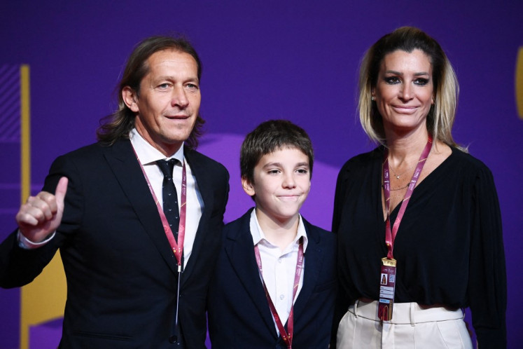 Soccer legend: Former Spanish footballer Michel Salgado (L), his wife Malula and son Miguel arrive for the draw for the 2022 World Cup in Qatar at the Doha Exhibition and Convention Center on April 1, 2022.
