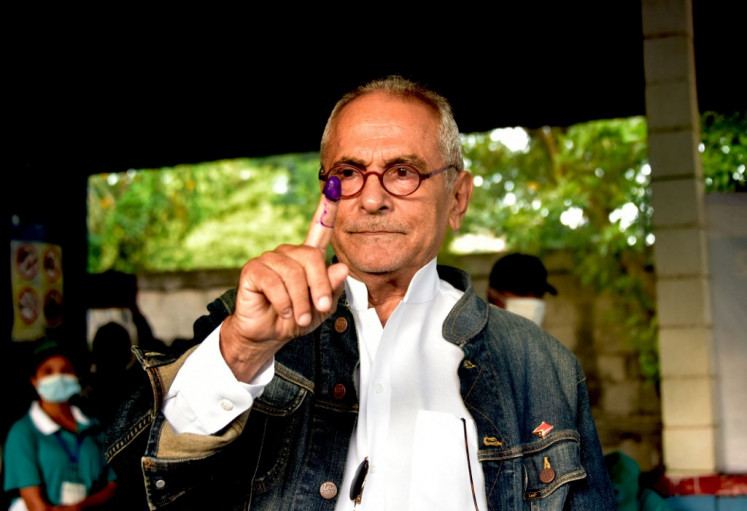 Candidate for president Jose Ramos Horta gestures as he casts his ballot during the second round of presidential elections in Dili on April 19, 2022. 