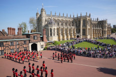Royal serenade: The Band of the Coldstream Guards (left), play “Happy Birthday” to mark the 96th birthday of the United Kingdom’s Queen Elizabeth II on Thursday, alongside the 1st Battalion of the Coldstream Guards during the Changing of the Guard ceremony at Windsor Castle.
