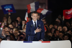 French President and La Republique en Marche (LREM) party candidate for re-election Emmanuel Macron celebrates after his victory in France's presidential election, at the Champ de Mars in Paris, on April 24, 2022. 