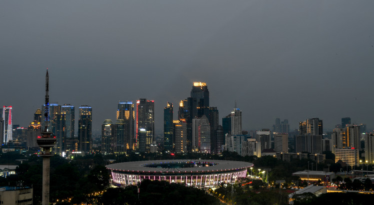 The Gelora Bung Karno stadium is seen next to Jakarta's Sudirman Central Business District (SCBD) on Aug. 18, 2018, ahead of the Asian Games.
