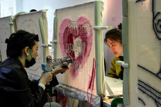 Stress relief: This photo taken on March 26 shows participants using craft guns to make mats and rugs at a tufting workshop in Beijing. 