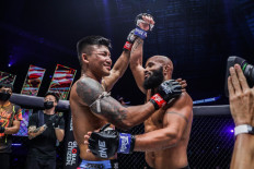 Lifting Each Other Up: Rodtang Jitmuangnon (left) raises Demetrious Johnson’s hand after their encounter inside the Circle at ONE X on March 26 