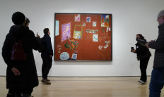 People look at Henri Matisse's 'The Red Studio' (1911) during a press preview on April 27, 2022, at the The Museum of Modern Art in New York, as the museum announces an exhibition focusing on the genesis and history of the art work. 