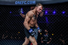 United States mixed martial arts fighter Jarred Brooks celebrates after defeating Bokang Masunyane at ONE 156 in Singapore