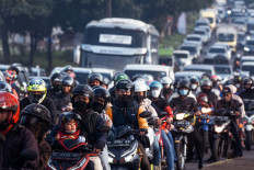 Motorists commute along a road in Nagreg, West Java, on April 30, as people head to their hometowns to celebrate Idul Fitri, the holiday which marks the end of the holy fasting month of Ramadan.