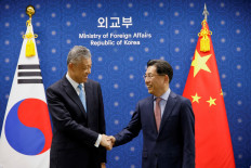 Chinese Special Representative on Korean Peninsula Affairs Liu Xiaoming shakes hands with South Korea's Special Representative for Korean Peninsula Peace and Security Affairs Noh Kyu-duk during a meeting at the Foreign Ministry in Seoul, South Korea, May 3, 2022.