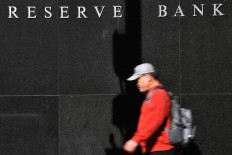 A man walks past the Reserve Bank of Australia in the central Business District of Sydney on March 19, 2020.



