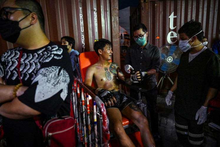 Fitness check: Medical staff attend to a fighter during an event by Fight Club Thailand in Bangkok.