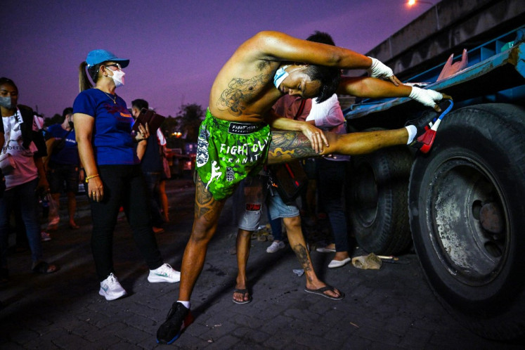 Prefight stretch: A fighter warms up before a competition at an event by Fight Club Thailand in Bangkok. 