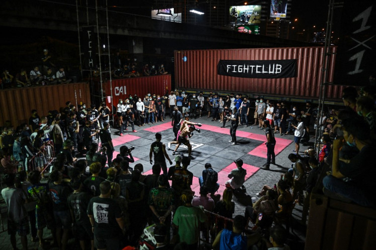 Human ring: Spectators watch as amateur fighters compete at an event by Fight Club Thailand, an underground organization that hosts unsanctioned fights of various martial arts disciplines.