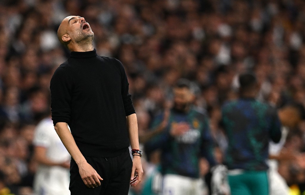 Manchester City's Spanish manager Pep Guardiola reacts during the UEFA Champions League semi-final second leg football match between Real Madrid CF and Manchester City at the Santiago Bernabeu stadium in Madrid on May 4, 2022. Real Madrid won the match 3-1.