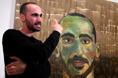 Artist Mostafa Azimitabar speaks about his work, titled 'Self-Portrait', as the finalists' work for the Archibald Prize is displayed in Sydney on May 5, 2022.