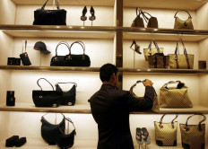 Crypto for luxury: An employee arranges bags on Nov. 25, 2008 at a Gucci showroom in Mumbai, India.