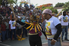 Strong fighter: Karina Vicente (left) and her brother Gabriel Vicente take part in the rain petition ritual in Zitlala, Guerrero, Mexico, on Thursday. 