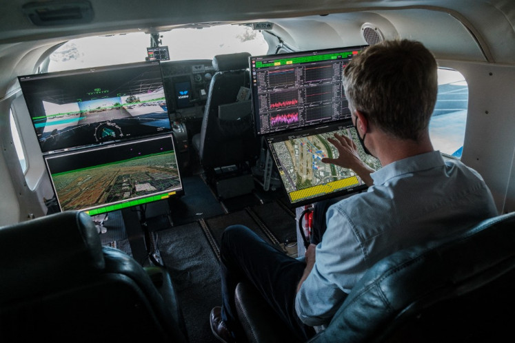 System check: Xwing CTO Maxime Gariel is seen checking on the systems in a Cessna 208B Grand Caravan.
