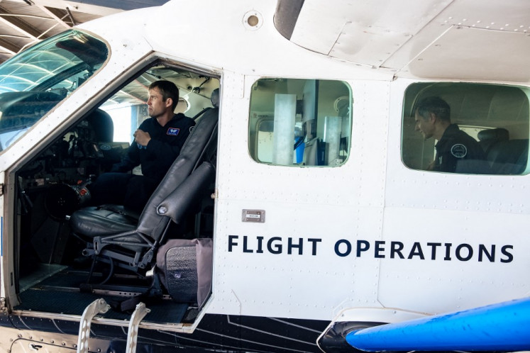 On the ground: Xwing safety pilots Ryan Olson (left) and Gabriele Di Francesco are seen checking on the flying systems in Cessna 208B Grand Caravan which has been outfitted with autonomous flying equipment at Xwing headquarters in Concord, California, the United States, on May 3. 