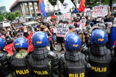 People display placards during a rally in front of the commission on elections in Manila on May 10, 2022, to protest against the results of the May 9 presidential election. The son of late Philippine dictator Ferdinand Marcos cemented a landslide presidential election victory on May 10, as Filipinos bet on a familiar dynasty to ease rampant poverty -- dismissing warnings the tarnished clan will deepen corruption and weaken democracy.