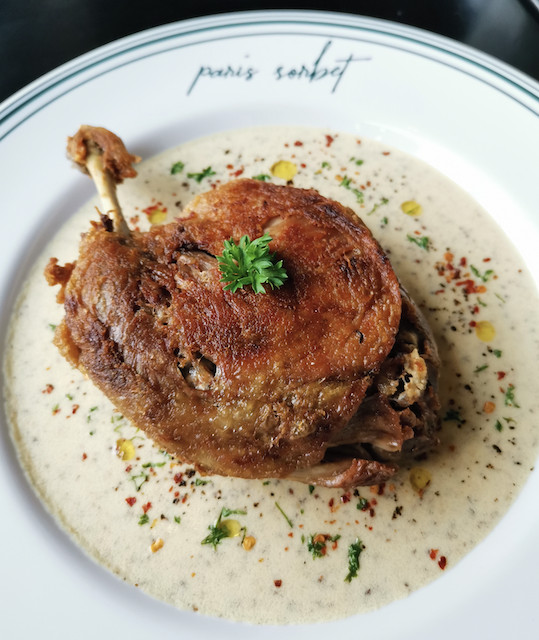 Duck tales: The Homemade Duck Confit is a slow-cooked duck leg with whole grain mustard sauce and gratin dauphinois. (Courtesy of Felix Martua)