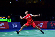 Indonesia’s Bilqis Prasista hits a return against France’s Yaelle Hoyaux during the group stages of the Thomas and Uber Cup badminton tournament in Bangkok on May 8, 2022. 