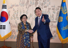 South Korean President Yoon Suk-Yeol shakes hands with former Indonesia President Megawati Sukarnoputri before a meeting at the new presidential office, in Seoul, South Korea May 11, 2022