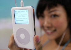 In this file photo taken on July 21, 2004, a model shows the latest model of Apple iPod during a press conference in Hong Kong.
