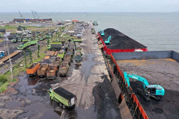 Heavy machinery is used to load coal onto trucks at Karya Citra Nusantara (KCN) Marunda Port in Jakarta on Jan. 17, 2022.