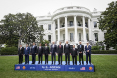 U.S. President Joe Biden (C) takes part in the family photo for the U.S.-ASEAN Special Summit on the South Lawn of the White House on May 12, 2022 in Washington, DC. Southeast Asian Leaders from the Association of Southeast Asian Nations (ASEAN) are visiting Washington, DC for a special summit hosted by U.S. President Joe Biden. Secretary General of ASEAN Dato Lim Jock Hoi, Prime Minister of Vietnam Pham Minh Chinh, Prime Minister of Thailand Prayut Chan-o-cha, Prime Minister of Cambodia Hun Sen, Sultan of Brunei Haji Hassan, President of Indonesia Joko Widodo, Prime Minister of Singapore Lee Hsien Long, Prime Minister of the Lao Peoples Democratic Republic Phankham Viphavan, Prime Minister of Malaysia Dato Sri Ismail Sabri bin Yaakob and Secretary of Foreign Affairs of the Philippines Teodoro Locsin. Drew Angerer/Getty Images/AFP 